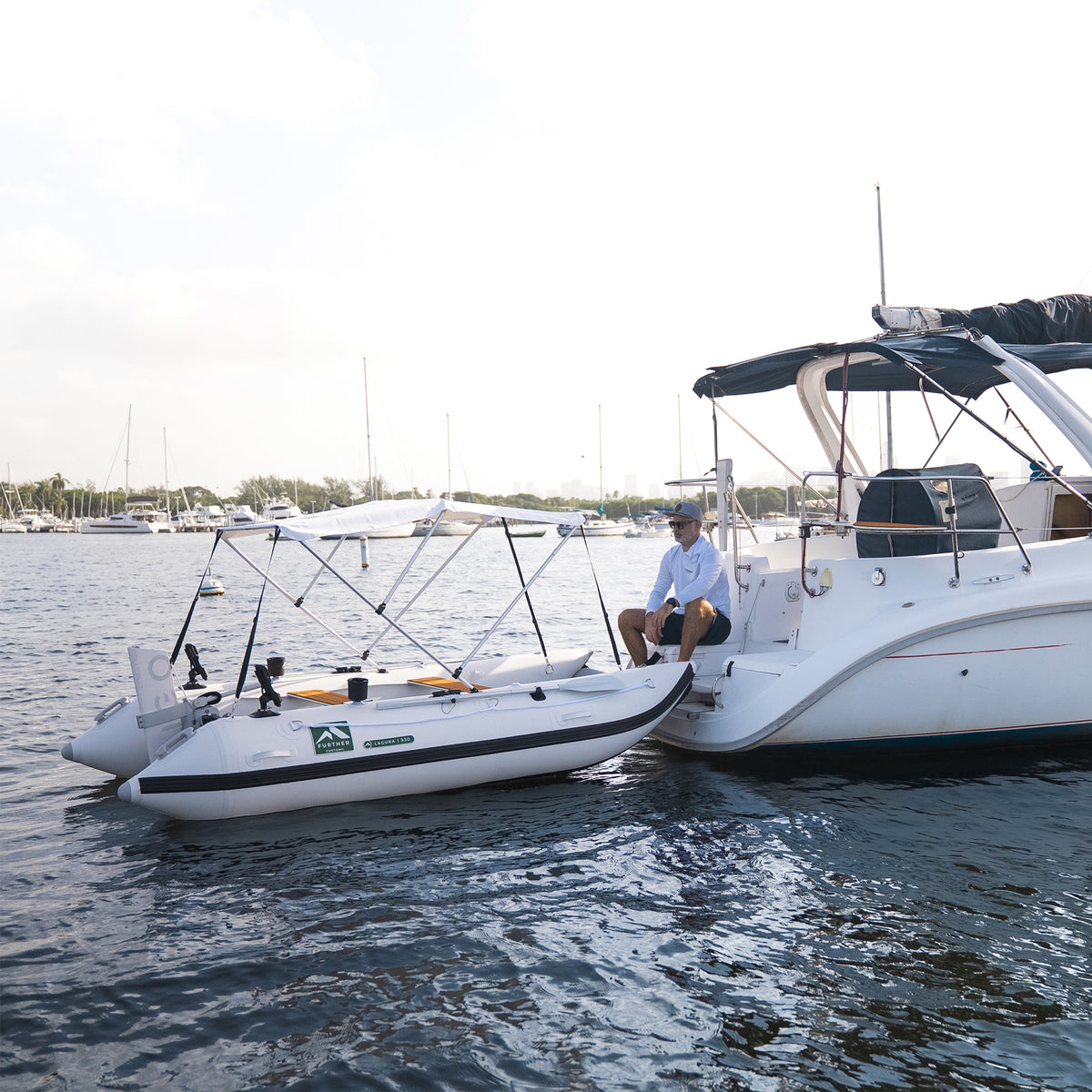 Remigo One Neo electric outboard engine on a Laguna 330 inflatable tender catamaran dinghy boat tied to a sailboat.